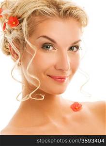 Beautiful young woman with fresh spring flowers in her hair close-up portrait
