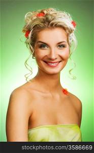 Beautiful young woman with fresh spring flowers in her hair. Spring concept.