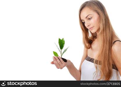 Beautiful young woman with green sprout of tree in her palms