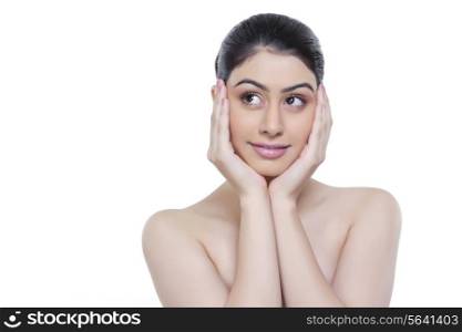 Beautiful young woman with head in hands over white background