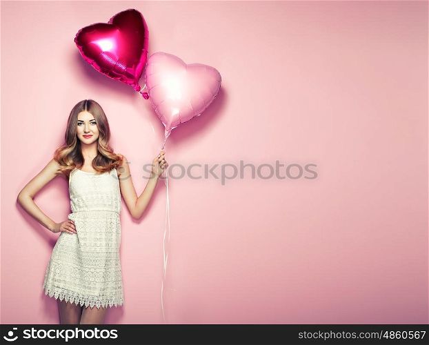 Beautiful young woman with heart shape air balloon on color background. Woman on Valentine's Day. Symbol of love