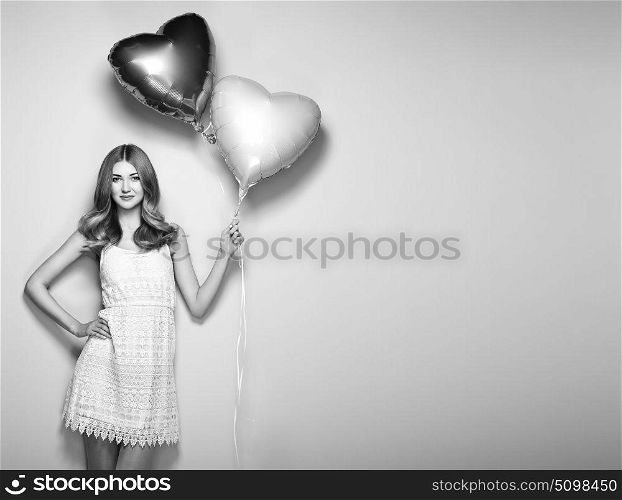 Beautiful young woman with heart shape air balloon. Woman on Valentine&rsquo;s Day. Symbol of love. Black and White photo