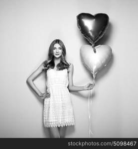 Beautiful young woman with heart shape air balloon. Woman on Valentine&rsquo;s Day. Symbol of love. Black and White photo