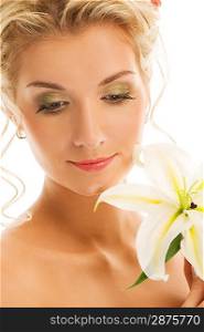 Beautiful young woman with lily flower. Close-up portrait