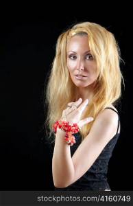 beautiful young woman with long blonde hair and a red bracelet on a dark background