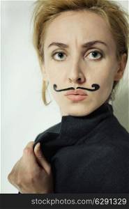 beautiful young woman with painted mustache wearing jacket