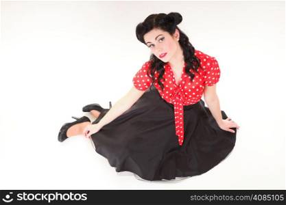 Beautiful young woman with pin-up make-up and hairstyle posing in studio