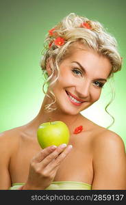 Beautiful young woman with ripe green apple