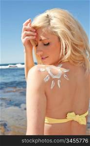 beautiful young woman with sun shape in sunscreen