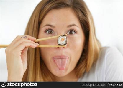 beautiful young woman with sushi rolls