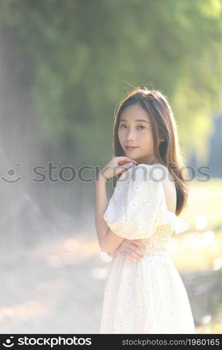 Beautiful young woman with white dress on bamboo forest background