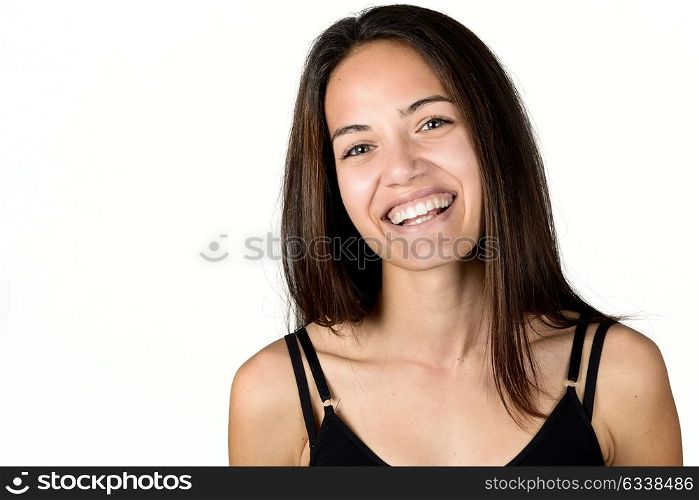 Beautiful young woman without make-up laughing. Beautiful girl with green eyes, model of fashion wearing black tank top on white background.