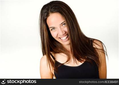 Beautiful young woman without make-up laughing. Beautiful girl with green eyes, model of fashion wearing black tank top on white background.