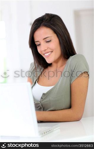 Beautiful young woman working at home on laptop computer