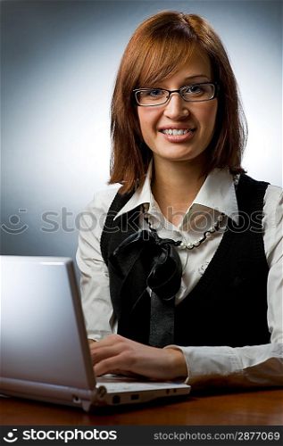 Beautiful young woman working on her laptop