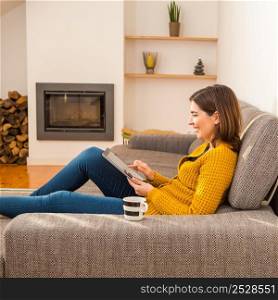 Beautiful young woman working with a tablet at home