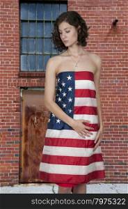 Beautiful young woman wrapped in a flag
