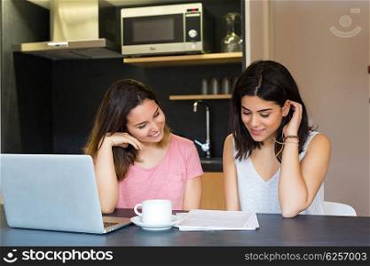 Beautiful young women at home studying for the final exams