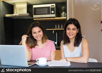 Beautiful young women at home studying for the final exams