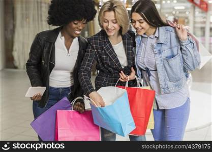 beautiful young women checking shopping bags