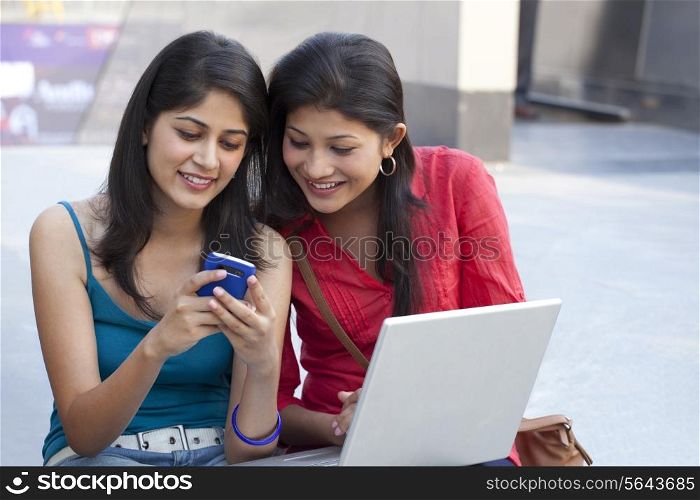 Beautiful young women using cell phone