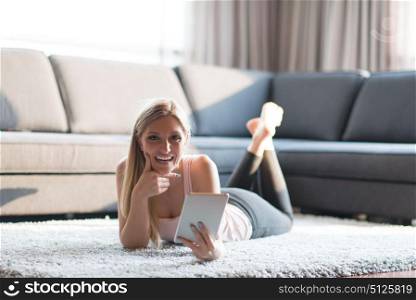 beautiful young women using tablet computer on the floor of her luxury home