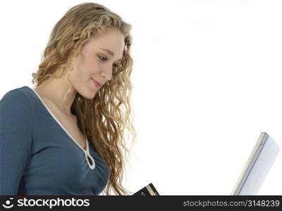 Beautifull young woman with laptop and credit card. Shot in studio over white.