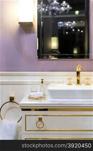 Beautifully Bright Restroom with Gold, White and Purple Furnishings