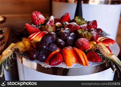 Beautifully decorated catering banquet table with different fresh fruits on corporate birthday party event or wedding celebration.. Beautifully decorated catering banquet table with different fresh fruits on corporate birthday party event or wedding celebration