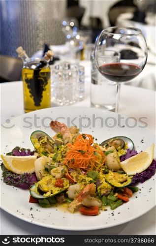 Beautifully plated seafood medley consisting of mussels, scallops and shrimp.