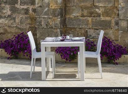 Beautifully white served table with flowers