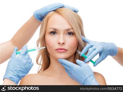 beauty and cosmetic surgery concept - woman face and beautician hands with syringes