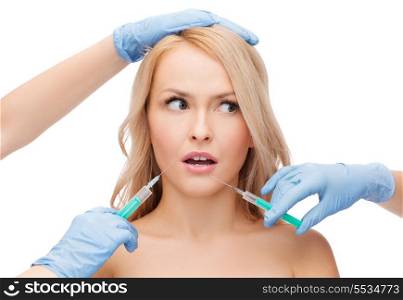 beauty and cosmetic surgery concept - woman face and beautician hands with syringes
