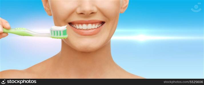 beauty and dental health concept - beautiful woman with green toothbrush
