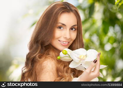 beauty and eco cosmetology concept - beautiful woman with orchid flower