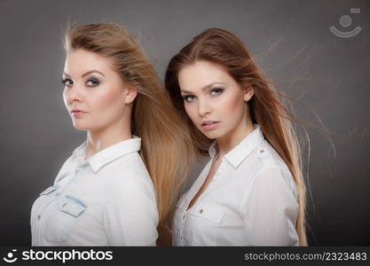 Beauty and fashion of woman. Attractive glamorous stunning girls. Portrait of gorgeous perfect styled trendy women photomodels posing together.. Two beautiful photomodels portrait.