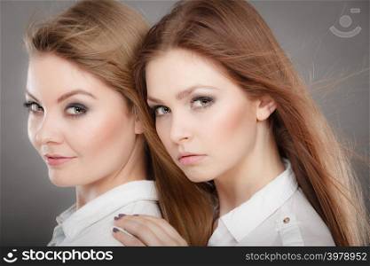 Beauty and fashion of woman. Attractive glamorous stunning girls. Portrait of gorgeous perfect styled trendy women photomodels posing together.. Two beautiful photomodels portrait.
