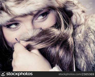 Beauty and fashion of women. Wintertime concept. Portrait of attractive cute girl in fur cap hat. Studio shot.
