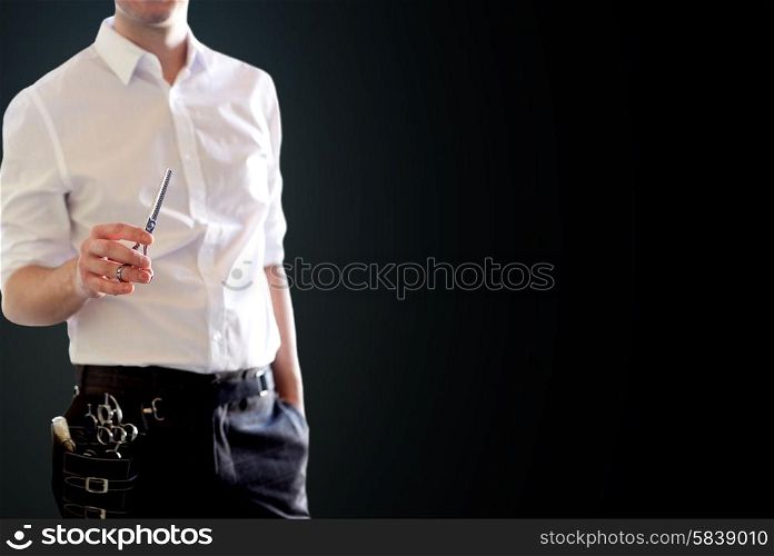 beauty and hair salon, hairstyle and people concept - close up of male stylist with scissors over blank black background