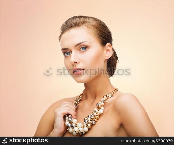 beauty and jewelery concept - beautiful woman wearing statement necklace with pearls