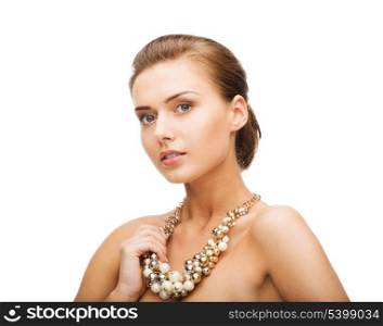 beauty and jewelery concept - beautiful woman wearing statement necklace with pearls