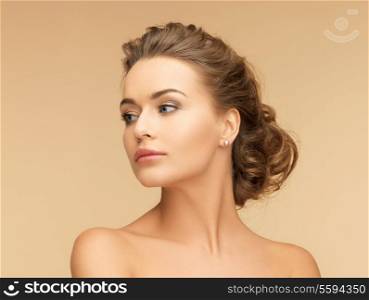 beauty and jewelery concept - beautiful woman with pearl earrings