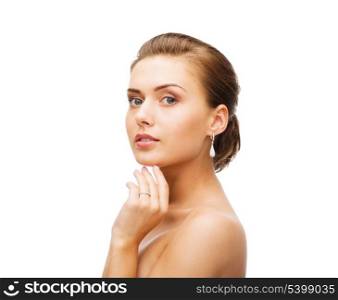 beauty and jewelry - beautiful woman wearing diamond earrings and wedding ring
