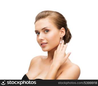 beauty and jewelry - beautiful woman wearing diamond earrings and wedding ring