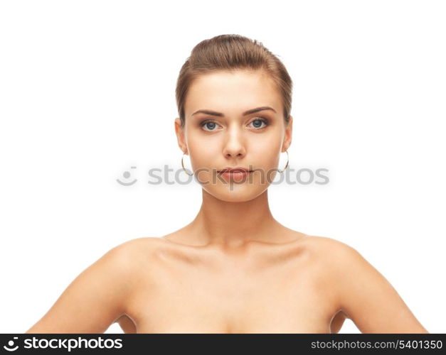 beauty and jewelry concept - beautiful woman wearing gold earrings