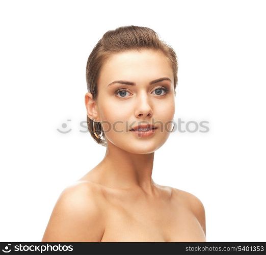 beauty and jewelry concept - beautiful woman wearing gold earrings