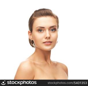 beauty and jewelry concept - beautiful woman wearing gold earrings