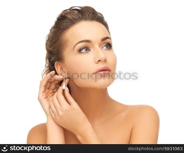 beauty and jewelry concept - beautiful woman wearing shiny diamond earrings. woman wearing shiny diamond earrings
