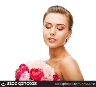 beauty and jewelry - woman wearing earrings and holding flowers