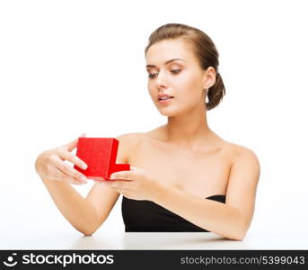 beauty and jewelry - woman with earrings, wedding ring and gift box